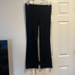 Athleta XL boot cut black leggings with slit at front bottom.